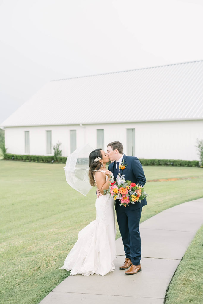 Beautiful couple with gorgeous veil with a classic white barn in Texas by Christina Elliot Photography. poses for bride and groom farmhouse wedding how to dress for a summer wedding outfits for bride and groom poses for bride and groom classic wedding dress for bride classic suit for groom summer outfits for wedding white barn wedding #texasweddingphotographer #farmhousewedding #farmhouseweddinginspo #texasphotographer #farmhouseweddingdecor #texasweddinglocations