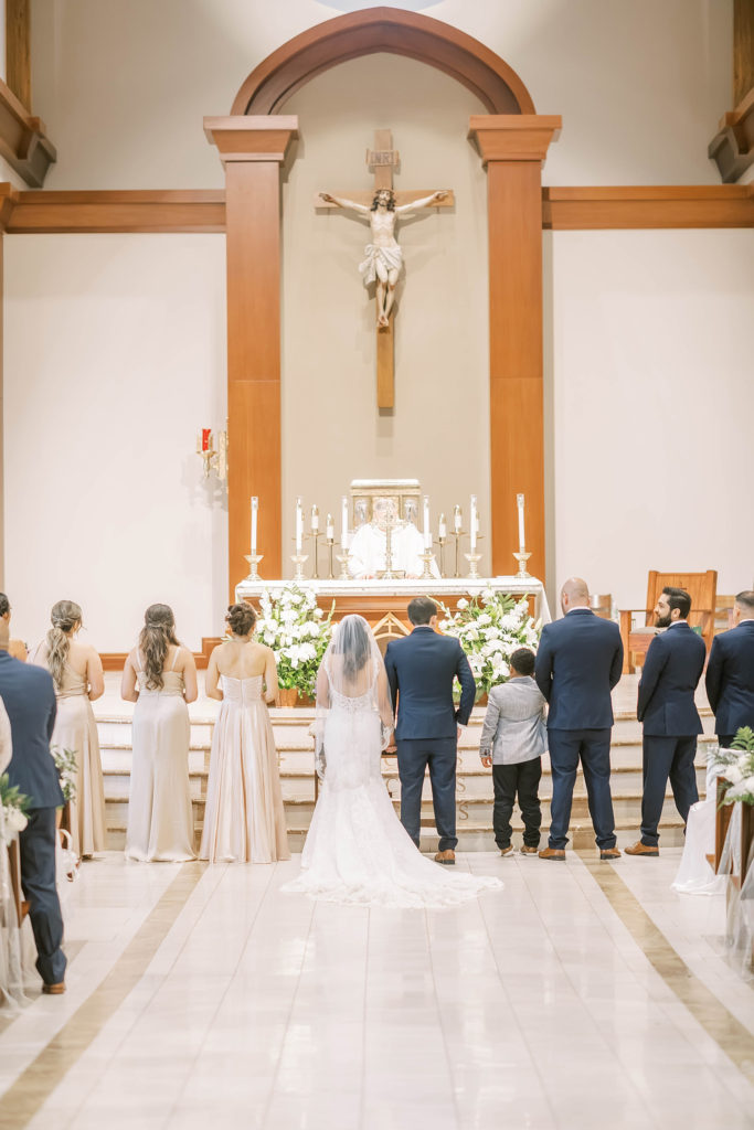 Beautiful photo of wedding party standing at the altar in a church wedding for a farmhouse summer wedding in Texas by Christina Elliot Photography. church weddings wedding party poses photographing the ceremony how to dress the wedding party farmhouse wedding decor inpso summer wedding colors altar pictures wedding ceremony photos #texasweddingphotographer #farmhousewedding #farmhouseweddinginspo #texasphotographer #farmhouseweddingdecor #texasweddinglocations