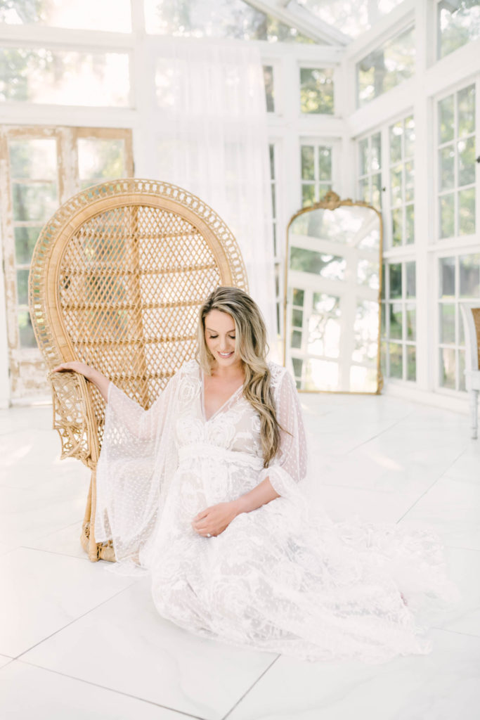Sitting on the floor in front of a wooden wicker chair in a beautiful white studio in Houston, Texas this mother to be is glowing from head to toe and absolutely beautiful. white lace maternity dress baby on the way simplistic maternity smile #christinaelliottphotography #christinaelliottmaternityphotographer #texasmaternitysession #houstonphotographers #oakateliermaternity #houstonmaternity #maternityphotos #soontobemom #stunningwhitematernitydress #motherandbaby #southernmaternity