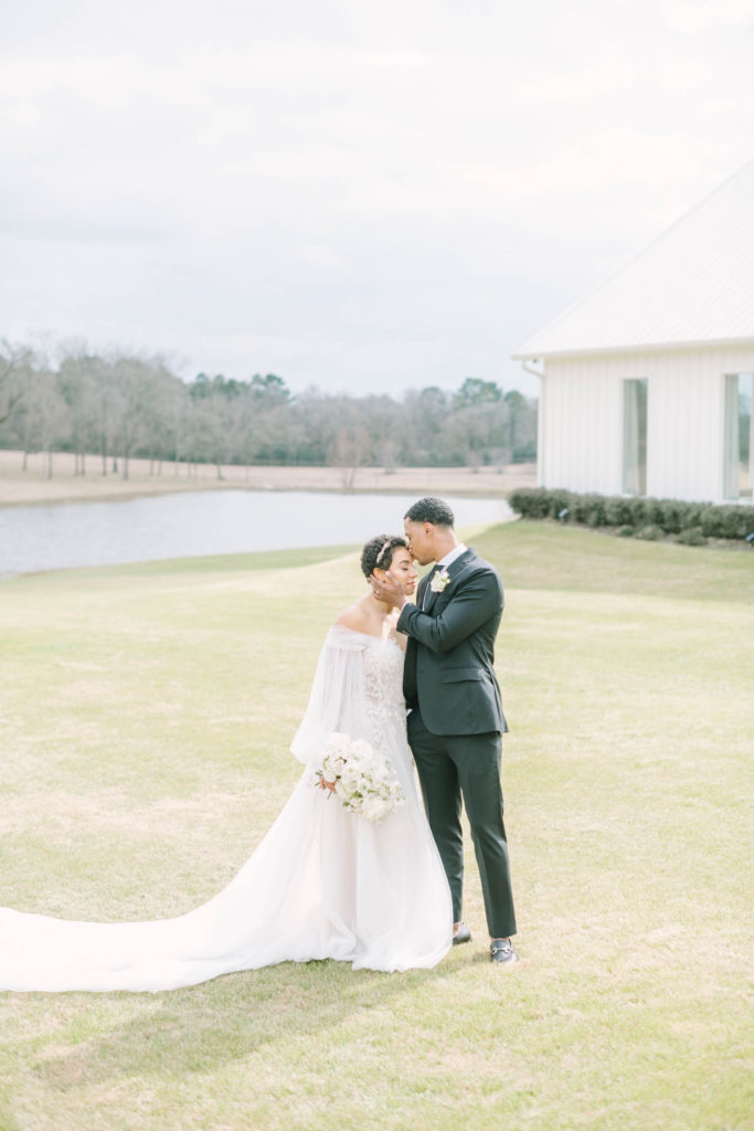 A bride and groom close their eyes and savor the moment on their wedding day outside the Farmhouse Montgomery by Christina Elliott Photography. young love newly wed Texas weddings Houston Photographers black and white wedding #christinaelliottphotography #christinaelliottweddings #TheFarmhouseMontgomery #farmhouseweddings #texasweddings #houstonweddingphotographers #mrandmrs #tildeathdowepart #weddingphotography #tietheknot #Houstonweddings #weddinginspiration #bride #groom