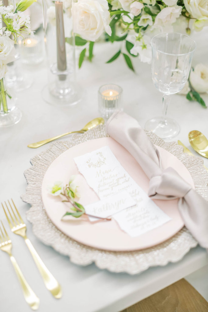 A farmhouse style wedding luncheon set up including gold silverware, light pink plate and white table cloth in Houston by Christina Elliott Photography. classy simple wedding luncheon table gold and light pink #christinaelliottphotography #christinaelliottweddings #TheFarmhouseMontgomery #farmhouseweddings #texasweddings #houstonweddingphotographers #mrandmrs #tildeathdowepart #weddingphotography #tietheknot #Houstonweddings #weddinginspiration #bride #groom