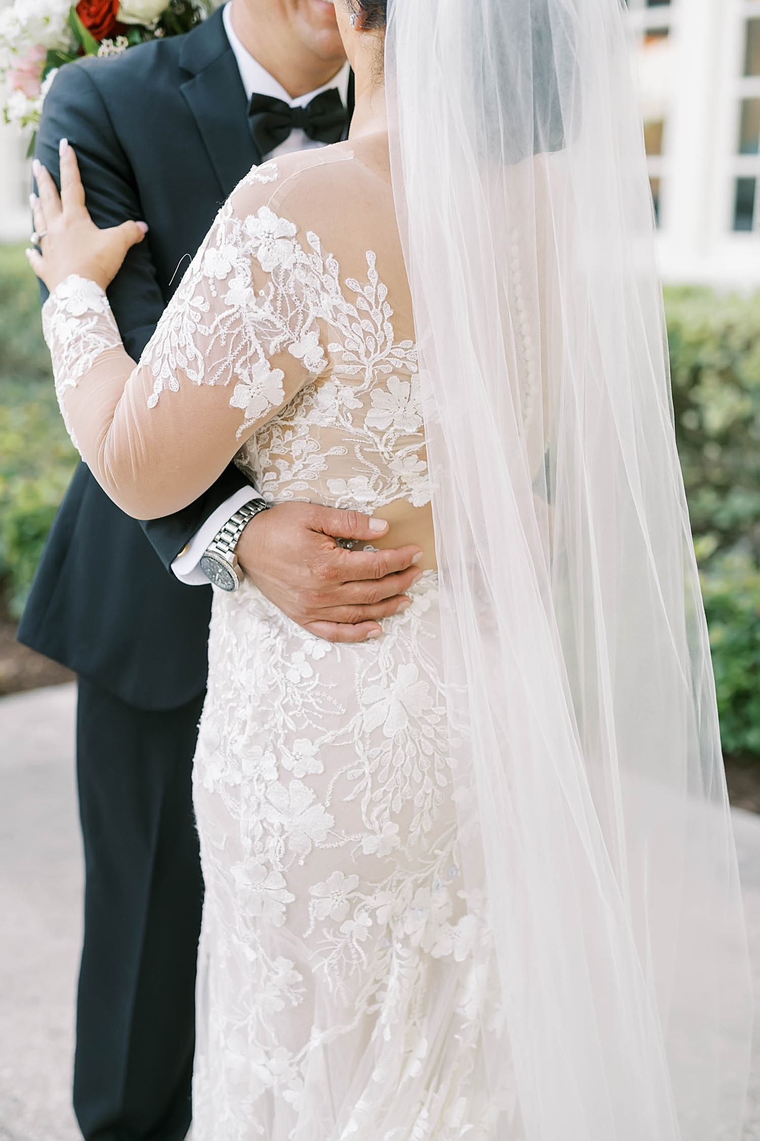 On Galveston Isle Christina Elliott Photography captures a stunning detailed photo of a brides sheer wedding gown with floral lace and long veil. floral detail wedding dress long sheer veil silver watch #christinaelliottphotography #christinaelliottweddings #houstonweddings #hotelgalvez #hotelgalvezweddings #galvestonweddings #mrsandmr #weddingdress #mariachiaband #sayido #newlymarried #lovebirds #classyweddings #weddingstyle #inlove #Gavestonweddingphotographer