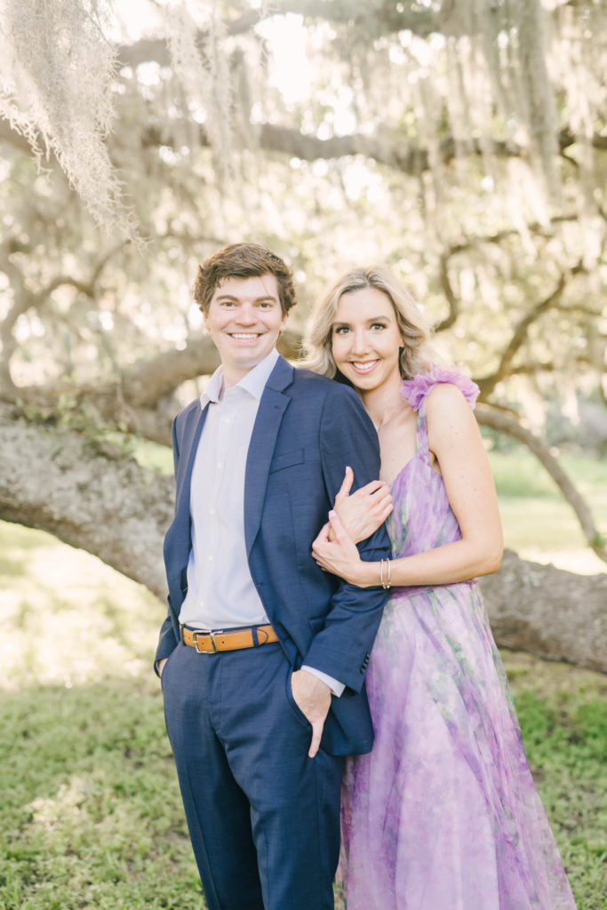 Soon-to-be married couple smiles wearing formal outfits during an engagement session in Houston, Texas by Christina Elliott Photography. formal engagement shots outdoor Texas engagements Houston area photographers #christinaelliottphotography #christinaelliottengagements #houstonengagements #brazosbendstateparkengagements #brazosbendphotography #houstonengagementphotographer #weddingannoucementphotos #houstonphotographers #couplegoals #soontobemarried #engaged #engagementphotos