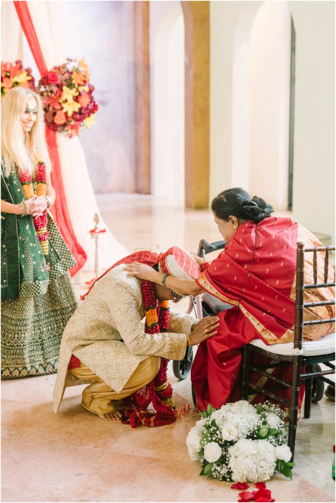 A tender moment where the mother of the groom blesses the groom during his wedding in Houston by Christina Elliott Photography a professional. mothers blessing during the marriage tender mother-son moment #christinaelliottphotography #christinaelliottweddings #thebelltoweron34th #belltowerwedding #houstonweddings #houstonweddingphotographers #mrandmrs #newlymarried #weddinginspiration #bridalgown #groomstyle #texasweddingphotographers #tietheknot #traditionalindianwedding