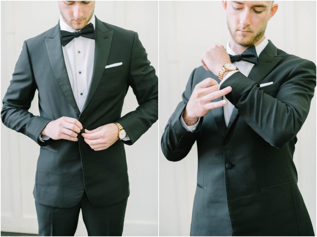 In Conroe, Texas a groom wearing a black suit and bowtie buttons his coat and cufflinks before his wedding captured by Christina Elliot Photography. black and white suit groom style black bowtie groom inspiration #christinaelliottphotography #christinaelliottweddings #houstontx #houstonweddings #houstonweddingphotographers #carriagehousewedding #conroetexas #texasweddingvenues #carriagehousechapel #cottageweddings #farmhousewedding #sweatheartweddinggown #countrywedding #weddinginspiration