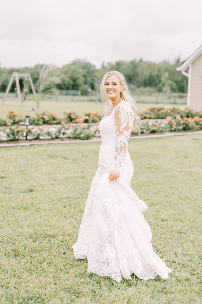 Bride with an all-lace wedding dress with long sleeves and sweetheart neckline in Texas by Christina Elliott Photography. romantic country wedding dress blonde bride #christinaelliottphotography #texasweddingphotographer #ranchwedding #countrychic