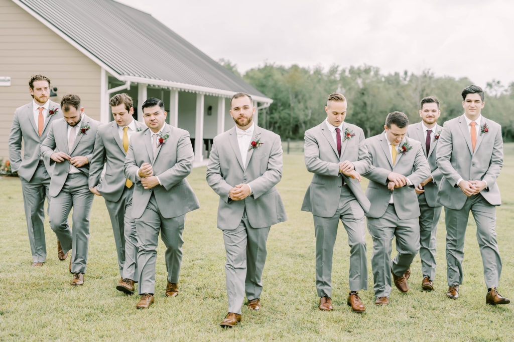 Christina Elliott Photography captures the groom and his groomsmen in light gray suits looking cool. Texas wedding photographer groomsmen style gray suit brown shoes #christinaelliottphotography #texasweddingphotographer #ranchwedding #countrychic