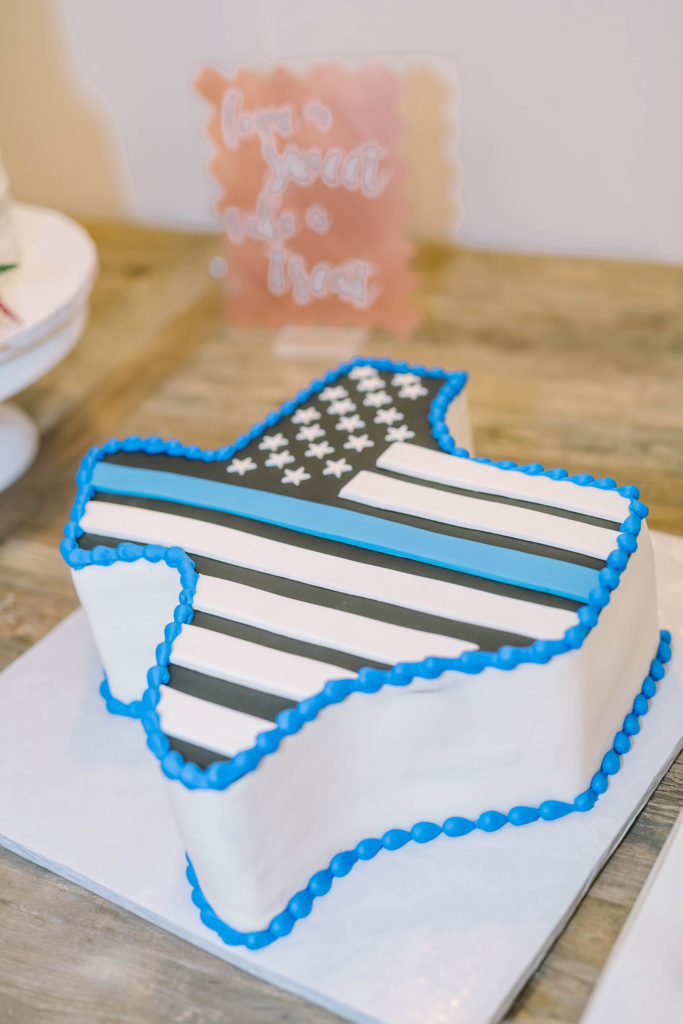 Christina Elliott Photography captures the groom's cake that is the shape of Texas with a police officer stripe. groom cake police groom cake Texas cake #christinaelliottphotography #texasweddingphotographer #ranchwedding #countrychic