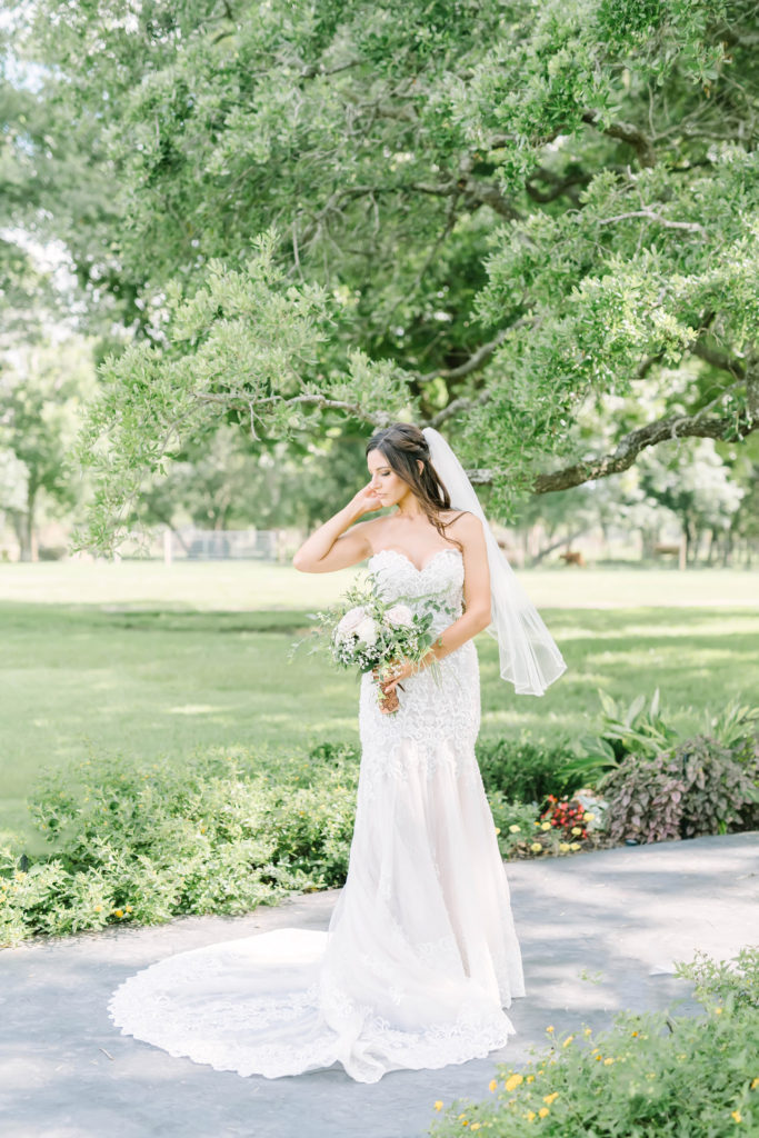 In Texas, Christina Elliott Photography captures a bride in a feminine mermaid wedding dress with lace and a sheer veil. mermaid wedding dress sheer veil #texasbridals #christinaelliottphotography #plantationwedding #bridalinspiration #TXwedding