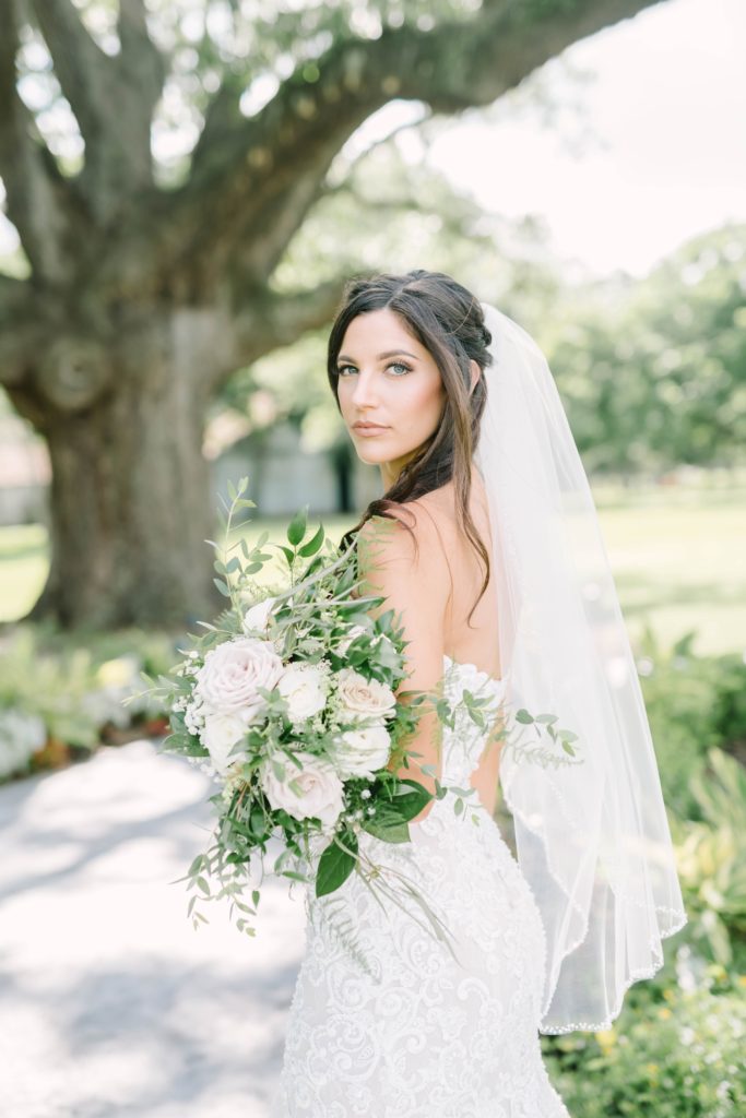 Bride with closed mouth wearing an intricate lace strapless wedding gown in Texas with Christina Elliott Photography. sheer midi veil romantic wedding dress #texasbridals #christinaelliottphotography #plantationwedding #bridalinspiration #TXwedding