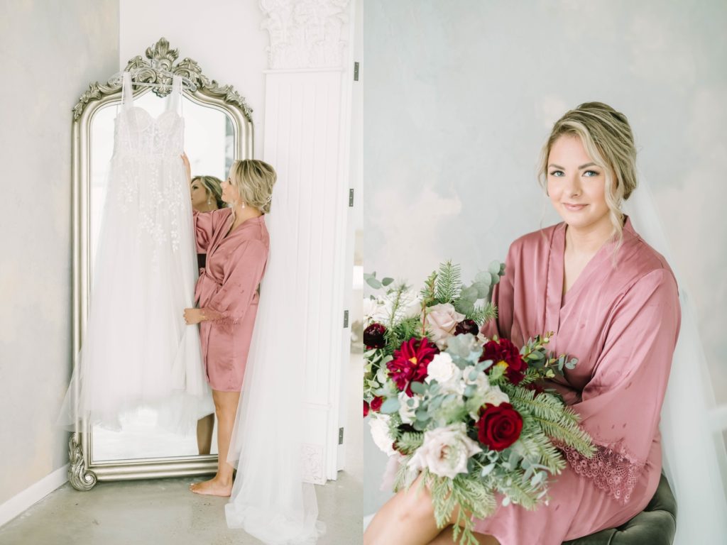 Bride holds a winter bridal bouquet while getting ready in her pink silk robe by Christina Elliott Photography. bridal getting ready portraits #christinaelliottphotography #theoakatelierwedding #Houstonwinterweddings #weddingphotographersHouston