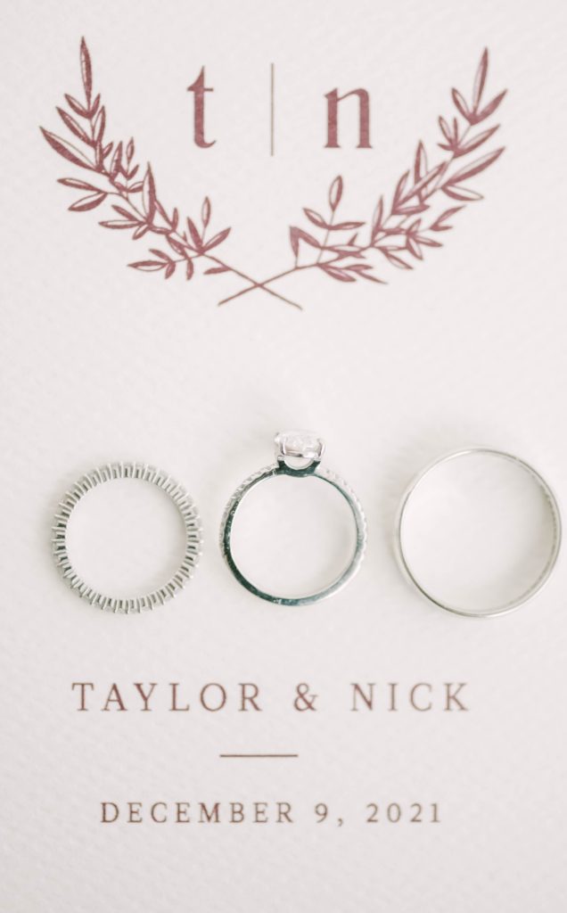 Christina Elliott Photography captures a flat lay photo of a wedding announcement with the wedding ring set. wedding rings on announcement #christinaelliottphotography #theoakatelierwedding #Houstonwinterweddings #weddingphotographersHouston