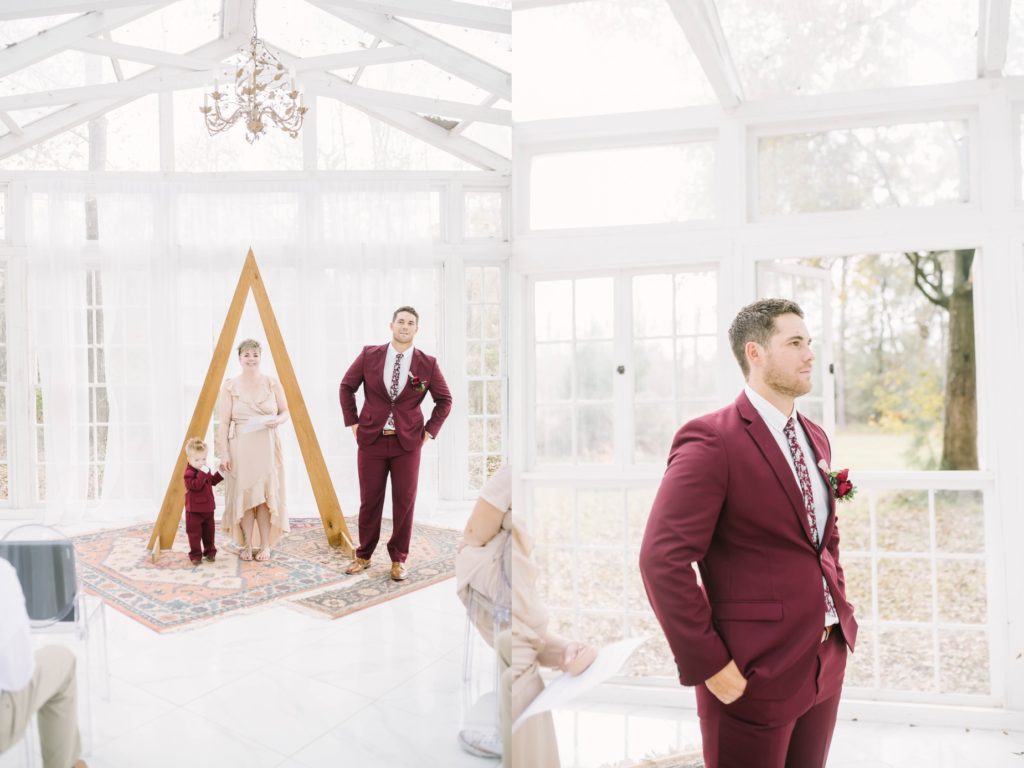 Groom and young son wait at the altar wearing a maroon suit and floral tie for a bride by Christina Elliott Photography. TX wedding boho wedding #christinaelliottphotography #theoakatelierwedding #Houstonwinterweddings #weddingphotographersHouston