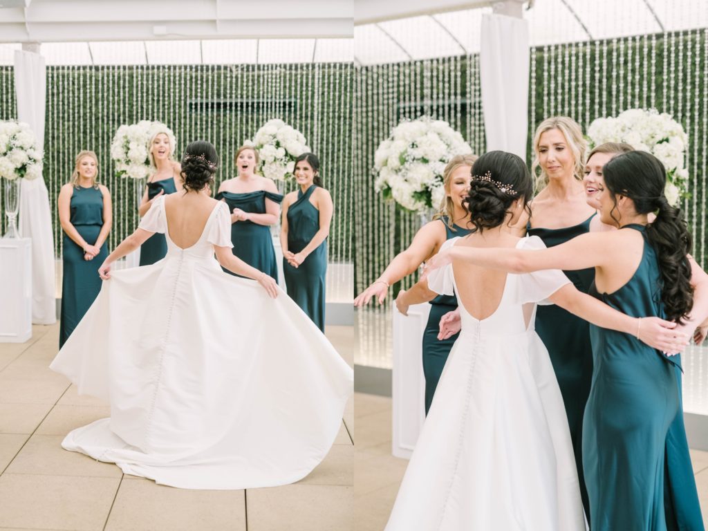 A group of bridesmaids reacts to the bride in her wedding dress at the Houston Hotel by Christina Elliott Photography. scoop back wedding dress first look #christinaelliottphotography #thesamhoustonhotel #houstonweddings #TXweddingphotographer