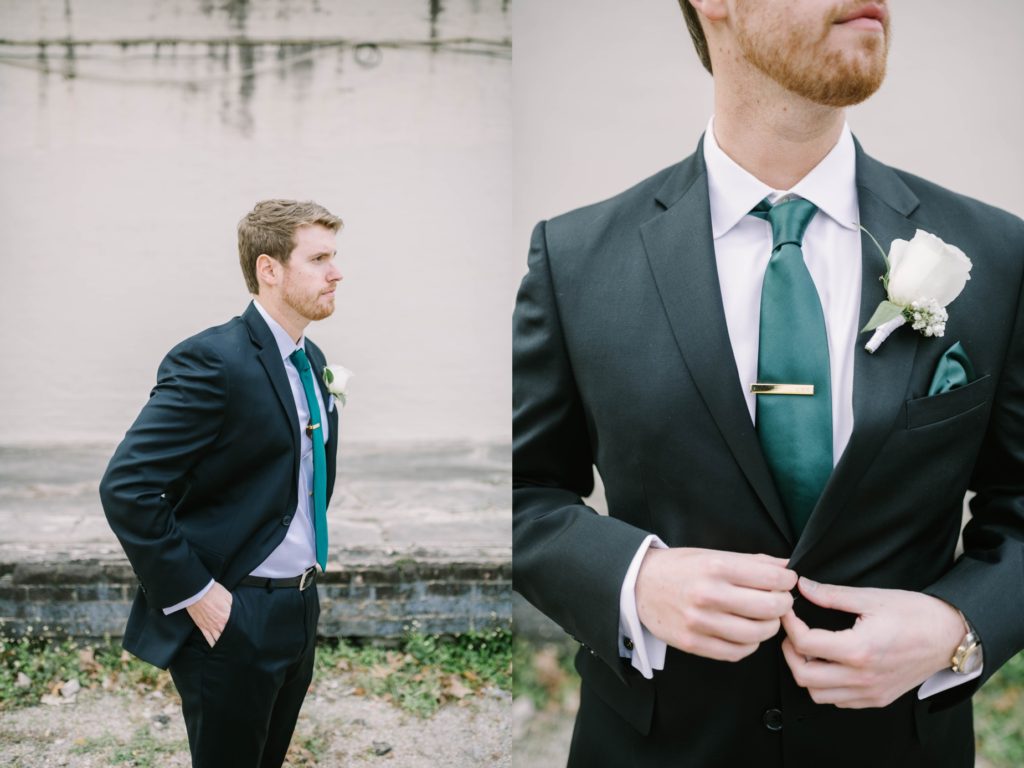 Groom buttons his top suit coat button with a gold tie bar by Christina Elliott Photography. Houston wedding photography gold tie bar green tie for wed #christinaelliottphotography #thesamhoustonhotel #houstonweddings #TXweddingphotographer