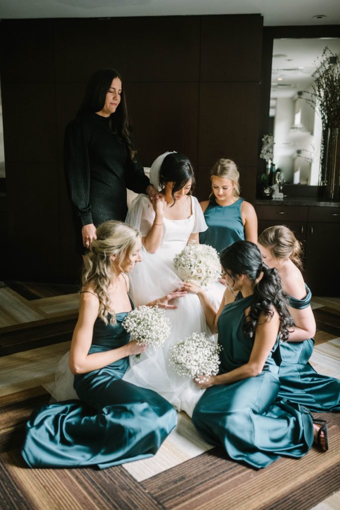 Christina Elliott Photography captures a bride kneeling with her bridesmaids in prayer in Houston Texas. bridal party praying deep green silk dresses #christinaelliottphotography #thesamhoustonhotel #houstonweddings #TXweddingphotographer