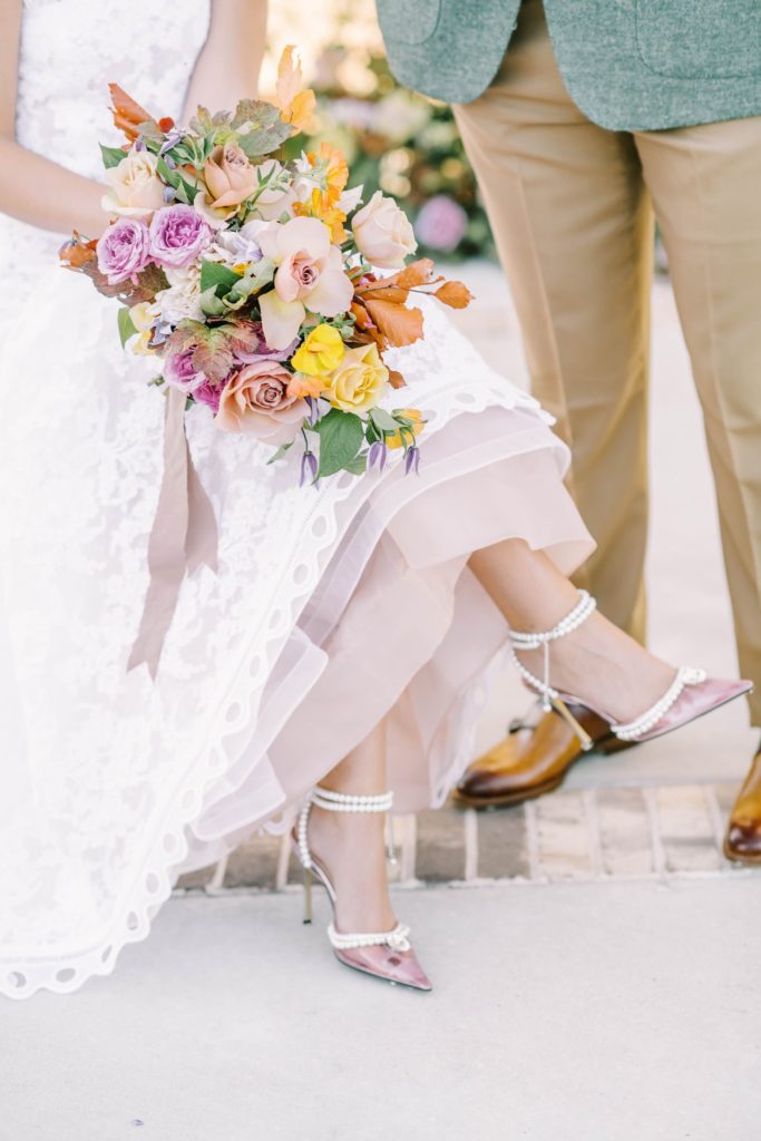 Christina Elliott Photography captures a bride with her pearl straps wedding heals and peach rose bouquet. pearl wedding shoe peach rose #christinaelliottphotography #Houstonweddings #arrowheadhill #weddingphotographersHouston #springwedding #sayIdo