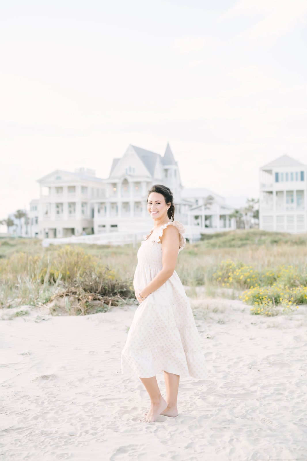 Bright airy maternity portrait of a woman on a summer day in sundress by Christina Elliott Photography. bright airy photographers Texas #ChristinaElliottPhotography #ChristinaElliottMaternity #Galvestonmaternityphotographers #maternityportraits
