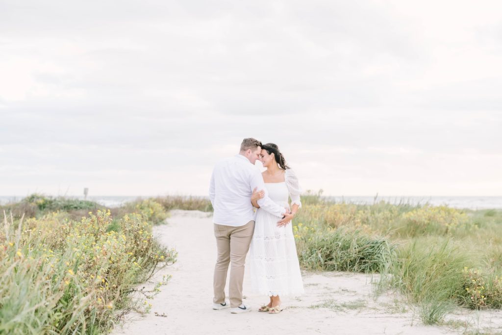 During a maternity session, a husband and wife put foreheads together capturing a moment by Christina Elliott Photography. serene maternity #ChristinaElliottPhotography #ChristinaElliottMaternity #Galvestonmaternityphotographers #maternityportraits