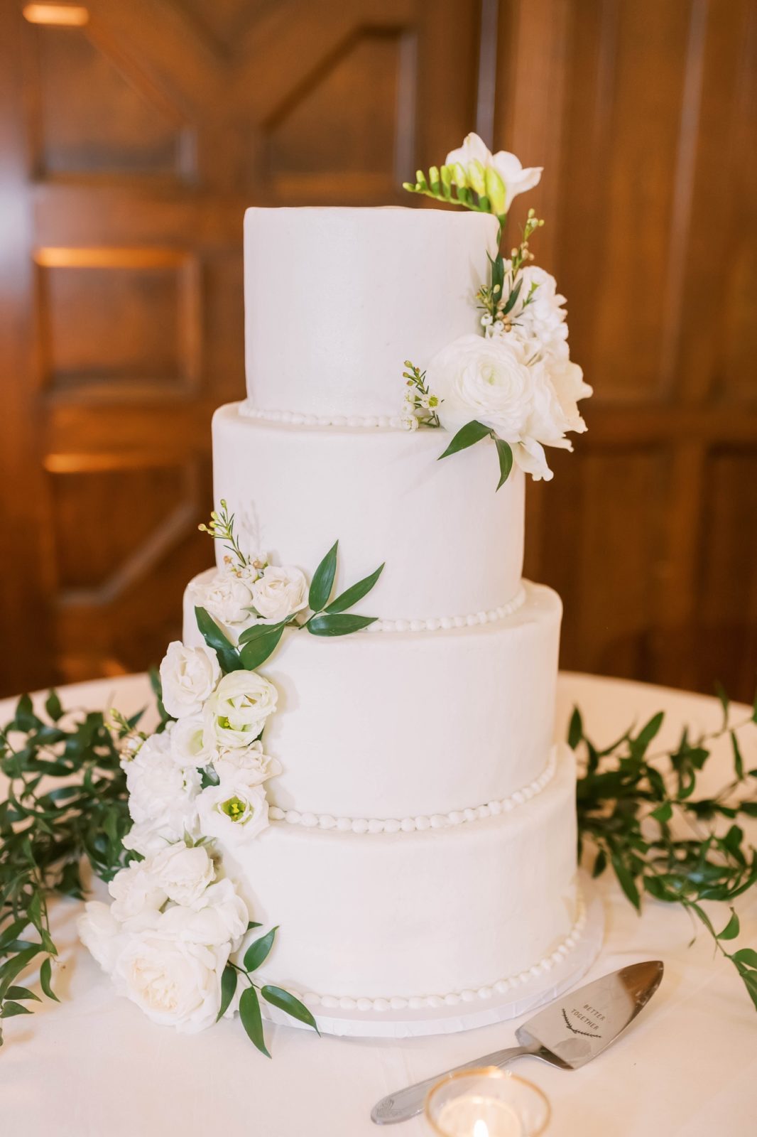 Christina Elliott Photography captures a four tier white buttercream simple wedding cake. four tier classic wedding cake #christinaelliottphotography #Houstonweddings #catholicchurchweddings #navyblue #sayIdo #Houstonweddingphotographers