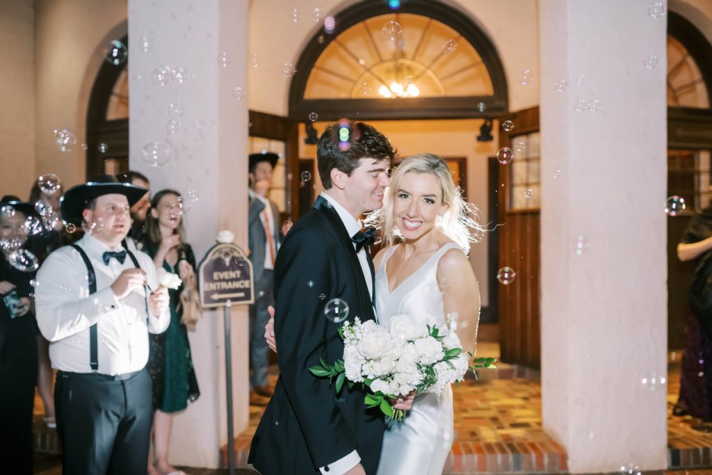 Christina Elliott Photography captures a fun wedding send-off with bubbles in Houston. bubble wedding send off cute wedding send off #christinaelliottphotography #Houstonweddings #catholicchurchweddings #navyblue #sayIdo #Houstonweddingphotographers
