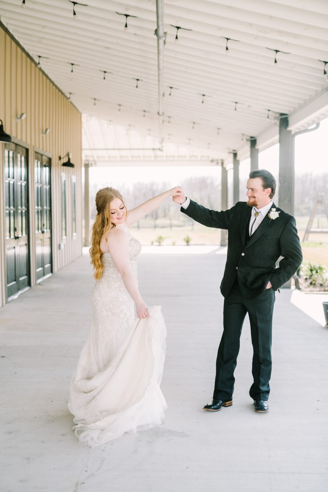 A bride spins in her wedding dress while holding the groom's hand by Christina Elliott Photography. dancing bridal portrait #ChristinaElliottPhotography #ChristinaElliottWeddings #StillWatersRanchWedding #Texasweddings #countrywedding #ranchwedding