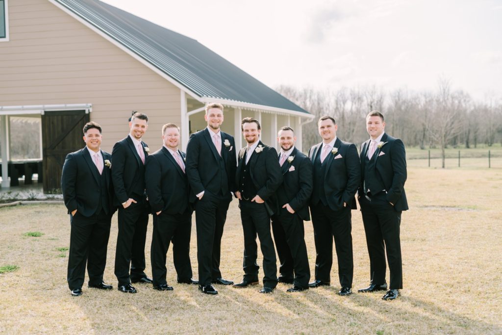 A groom with his groomsmen on a ranch in Alvin, Texas by Christina Elliott Photography. Texas wedding photographers #ChristinaElliottPhotography #ChristinaElliottWeddings #StillWatersRanchWedding #Texasweddings #countrywedding #ranchwedding