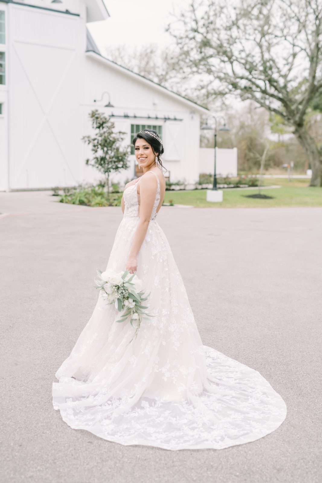 A bride wearing a princess cut wedding gown with lace details at a farmhouse by Christina Elliott Photography. lace white #ChristinaElliottPhotography #ChristinaElliottBridals #Houstonweddings #Farmhousewedding #TheSpringsVenue #BridalsHouston