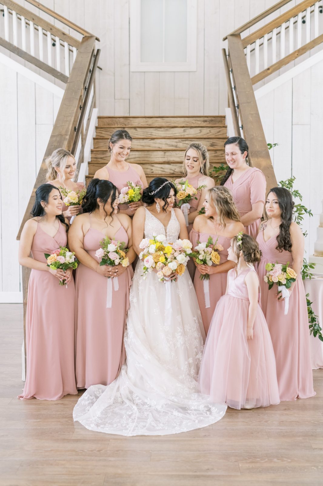 A bride with her bridesmaids all gathered around chatting by Christina Elliott Photography. brides best friends pink #ChristinaElliottPhotography #ChristinaElliottWeddings #Houstonwedding #TheSpringsVenue #EastHoustonweddings #Mrs #Mr