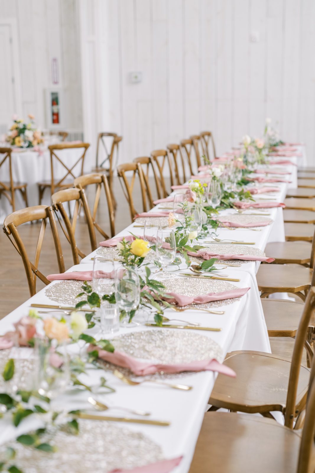 Wedding luncheon table with wooden chairs, pink napkins, and rose table decor by Christina Elliott Photography. spring luncheon #ChristinaElliottPhotography #ChristinaElliottWeddings #Houstonwedding #TheSpringsVenue #EastHoustonweddings #Mrs #Mr