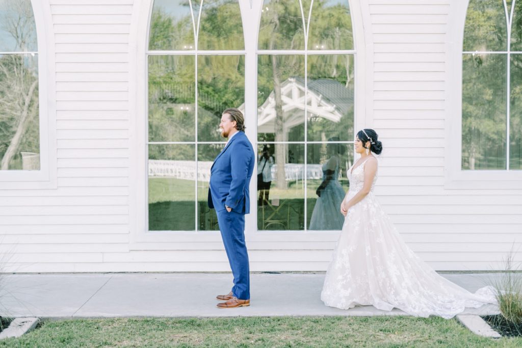 Groom faces away from the bride for the first look by Christina Elliott Photography. first look groom and bride brown shoes #ChristinaElliottPhotography #ChristinaElliottWeddings #Houstonwedding #TheSpringsVenue #EastHoustonweddings #Mrs #Mr