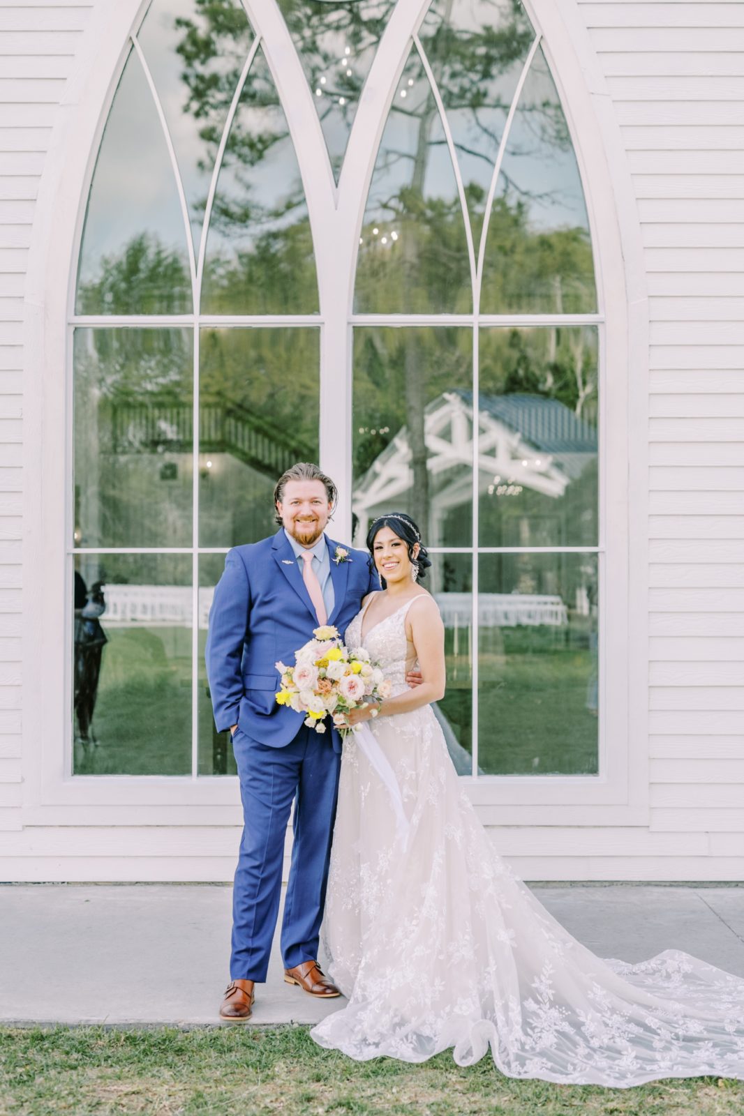 A bride and groom take a portrait in front of a glass window by Christina Elliott Photography in East Houston. bride groom portrait #ChristinaElliottPhotography #ChristinaElliottWeddings #Houstonwedding #TheSpringsVenue #EastHoustonweddings #Mrs #Mr