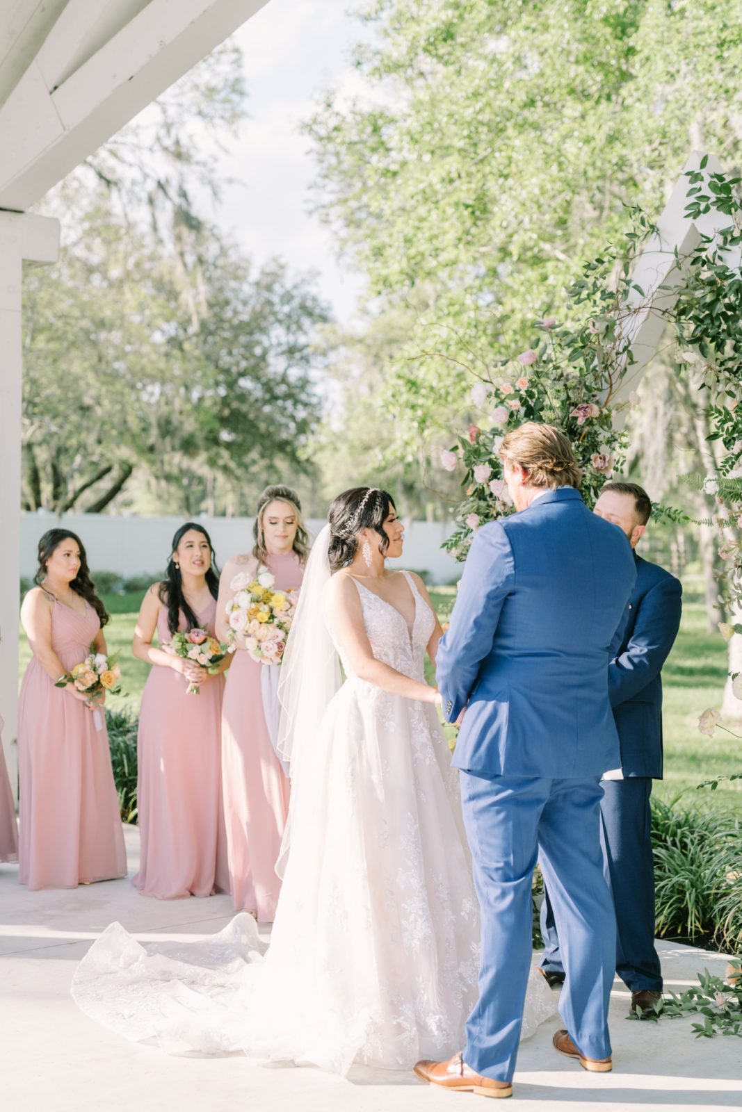 Warm sunshine wedding day with bride and groom holding hands at the altar by Christina Elliott Photography. sunshine altar portrait #ChristinaElliottPhotography #ChristinaElliottWeddings #Houstonwedding #TheSpringsVenue #EastHoustonweddings #sayIdo