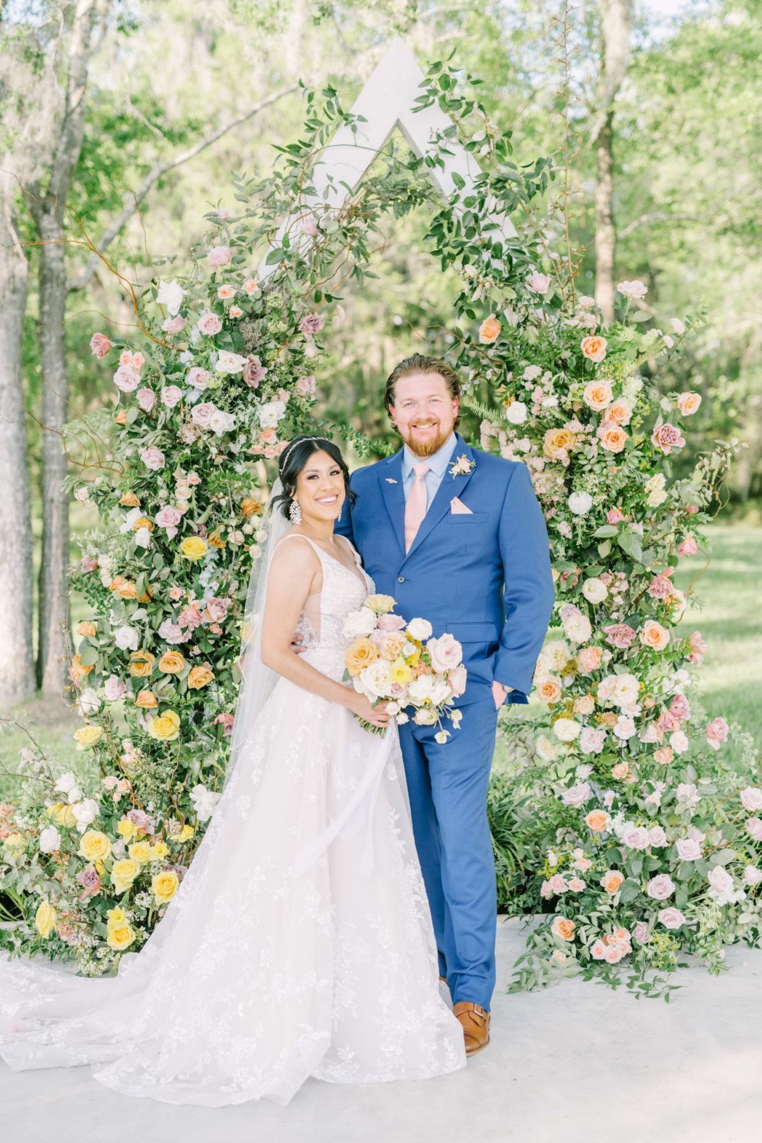 Christina Elliott Photography captures a portrait of the bride and groom standing in front of a floral altar. rose altar romantic #ChristinaElliottPhotography #ChristinaElliottWeddings #Houstonwedding #TheSpringsVenue #EastHoustonweddings #sayIdo