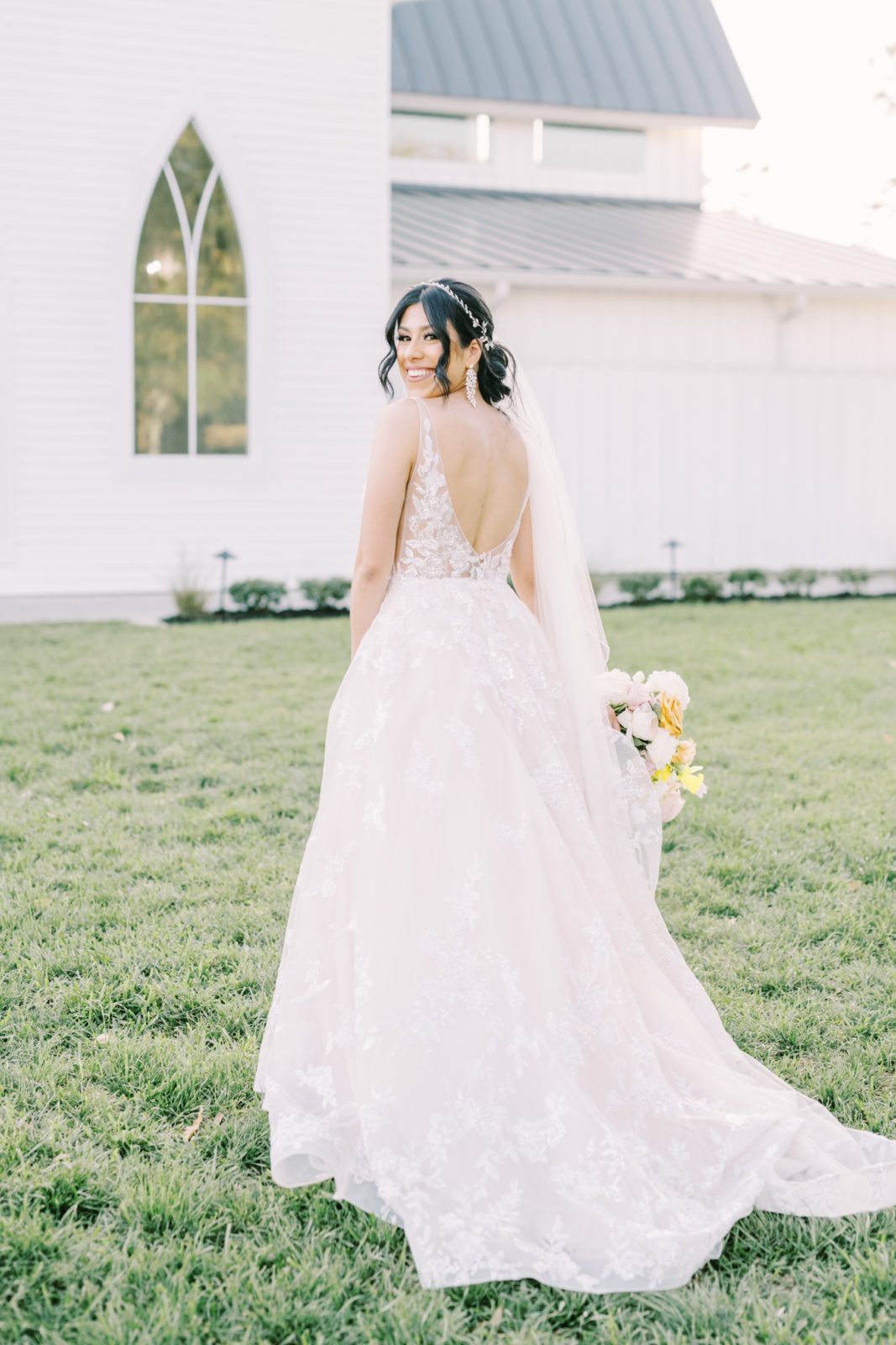 Christina Elliott Photography captures a bride with an updo and scoops back on her wedding day. Southern wedding vibes scoop back gown #ChristinaElliottPhotography #ChristinaElliottWeddings #Houstonwedding #TheSpringsVenue #EastHoustonweddings