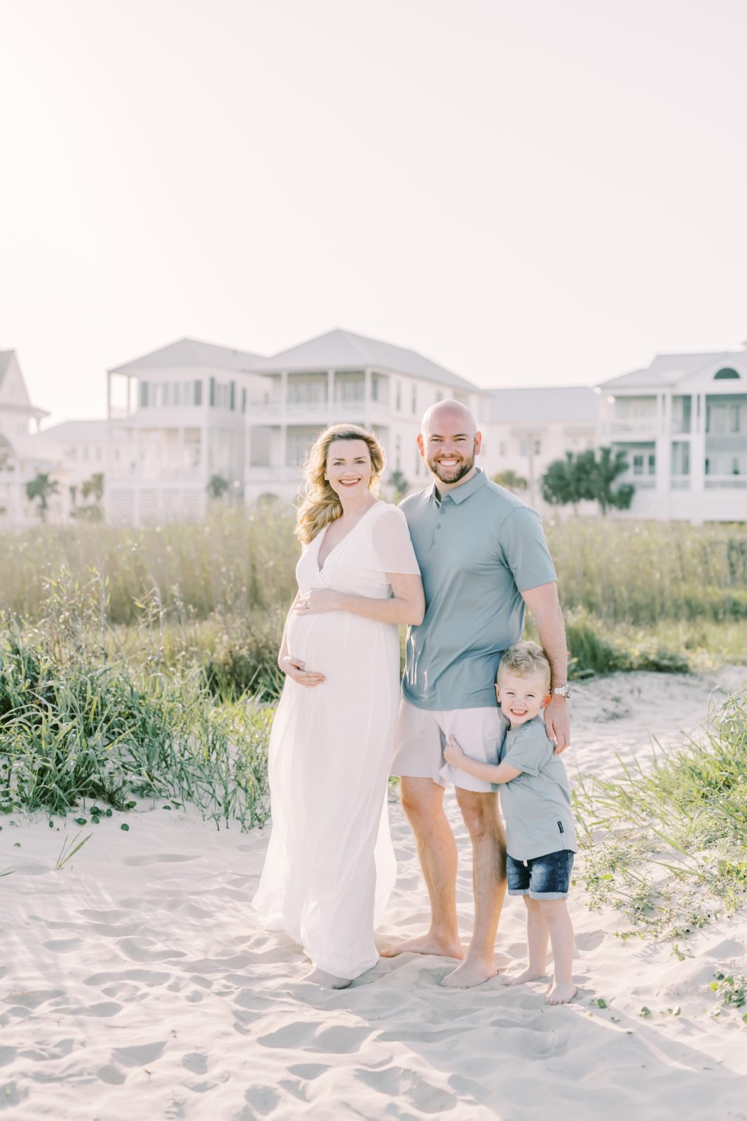 Family of three with a baby on the way at the beach captured by Christina Elliott Photography. family of three #ChristinaElliottPhotography #ChristinaElliottFamilies #GalvestonPhotography #Beachmaternityphotography #Texasfamilyphotographers