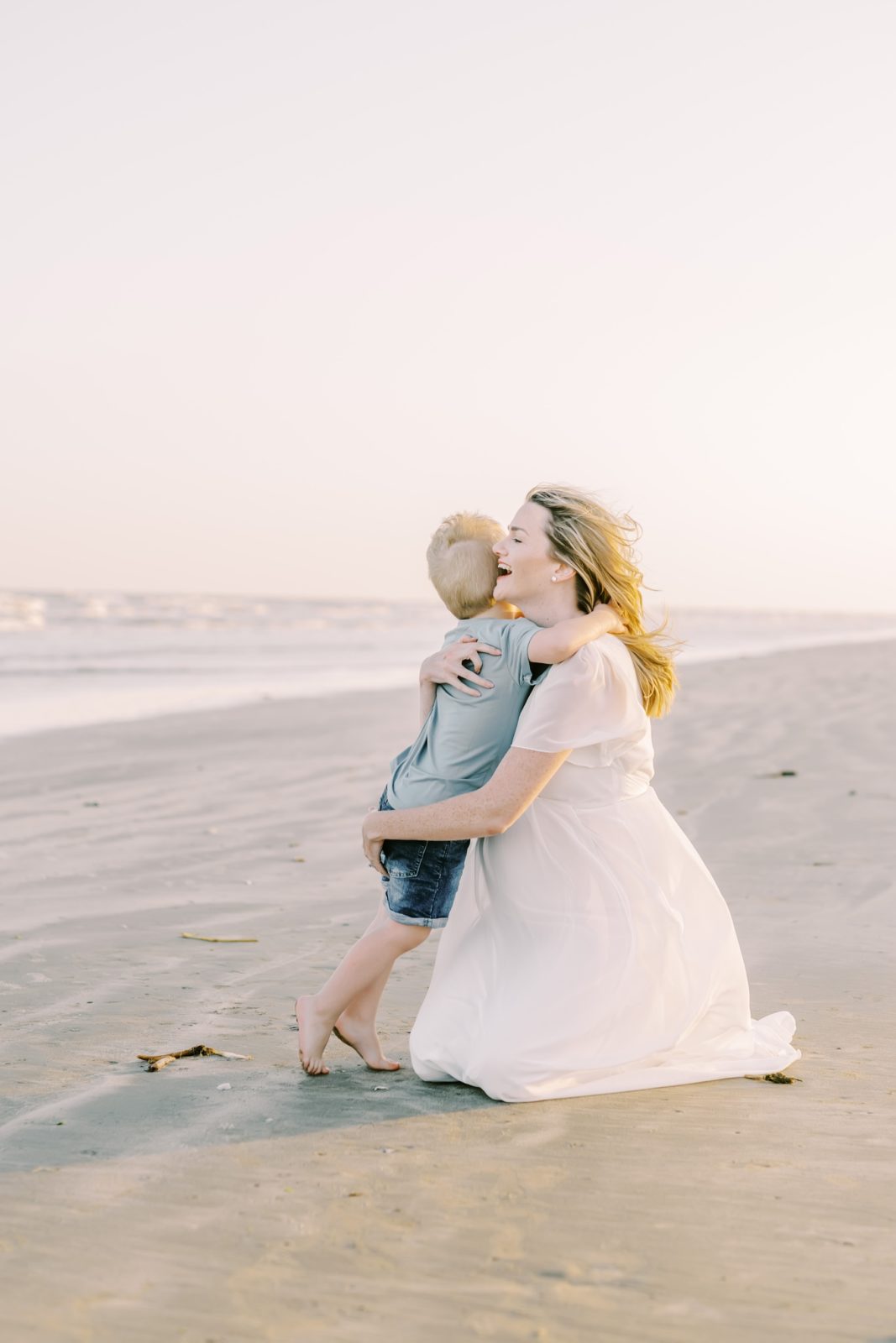 Little boy runs into his mother's arms on the Galveston Beach by Chrisitina Elliott Photography. mother embrace portrait #ChristinaElliottPhotography #ChristinaElliottFamilies #GalvestonPhotography #Beachmaternityphotography #Texasfamilyphotographers