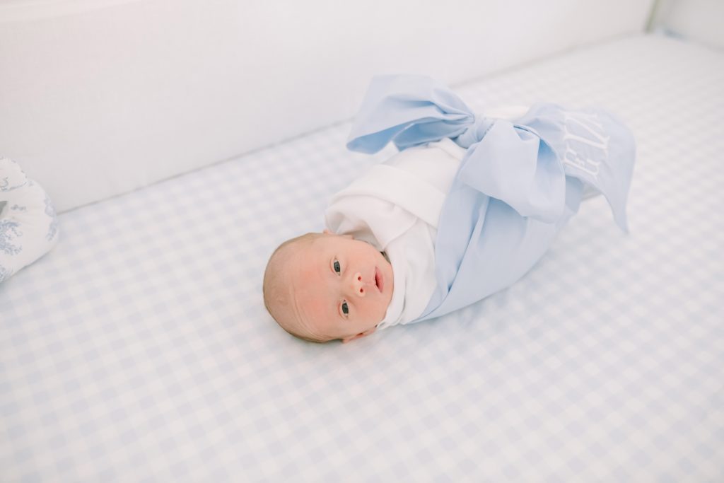 Lifestyle newborn portrait of a little girl in her crib captured by Christina Elliott Photography in Houston. baby girl in light blue #ChristinaElliottPhotography #ChristinaElliottNewborns #HoustonLifestyleNewborns #HoustonFamilyPhotographer