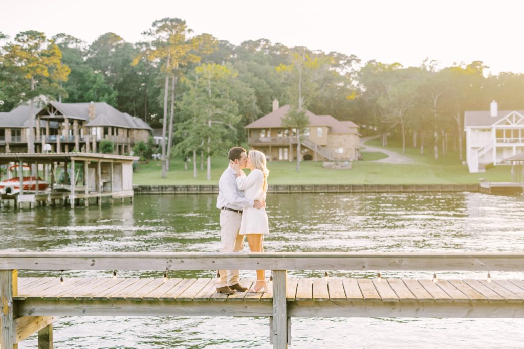 Engaged couple kiss on a wooden boat dock on Livingston Lake by Christina Elliott Photography. lake engagements Texas #ChristinaElliottPhotography #ChristinaElliottEngagements #LakeLivingston #summerengagements #Texasphotographer
