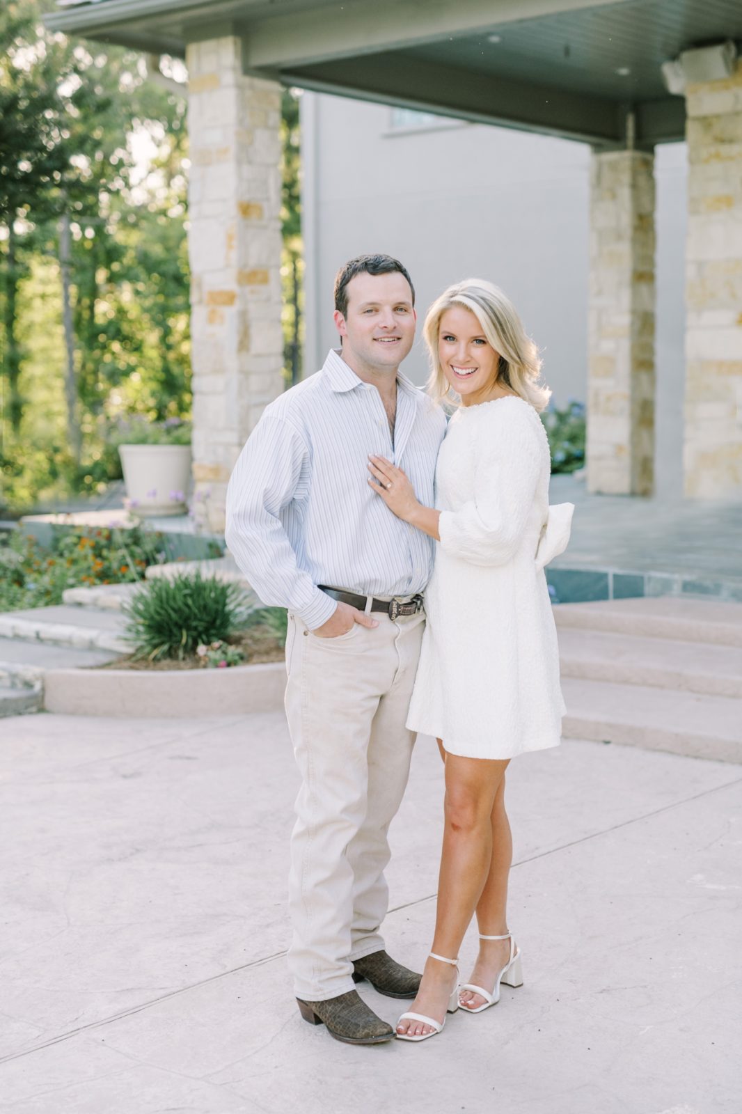 Woman in white and a man in a light blue smile for a portrait by Christina Elliott Photography. soon to be married wedding announcement pic #ChristinaElliottPhotography #ChristinaElliottEngagements #LakeLivingston #summerengagements #Texasphotographer